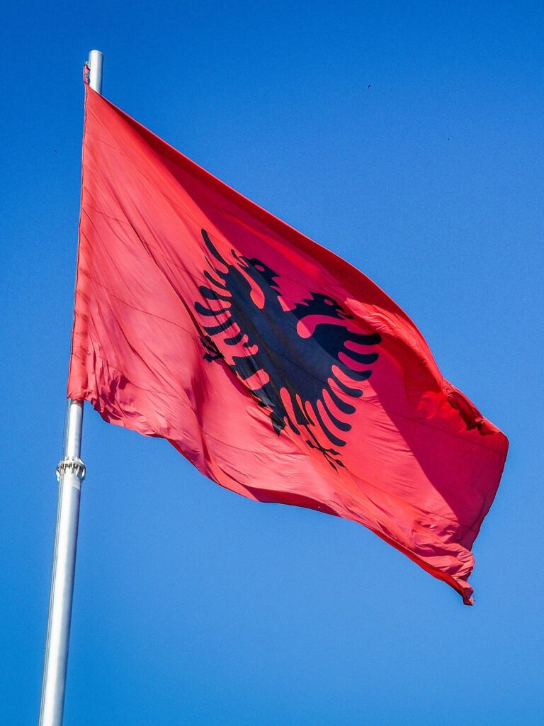 red Albanian flag with black double-headed eagle in the center